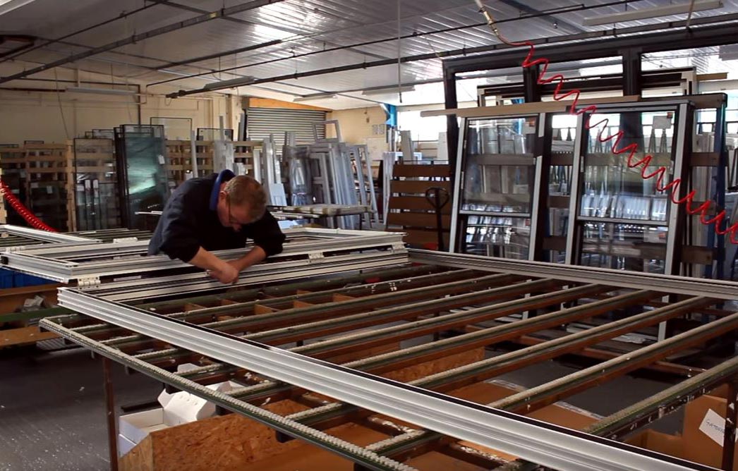 male working on aluminium frames in the supple factory