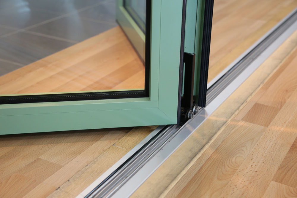 close up of the bi-fold door rail with mint green powder coating