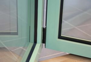 Powder coated bi-fold door supplied in chartwell green