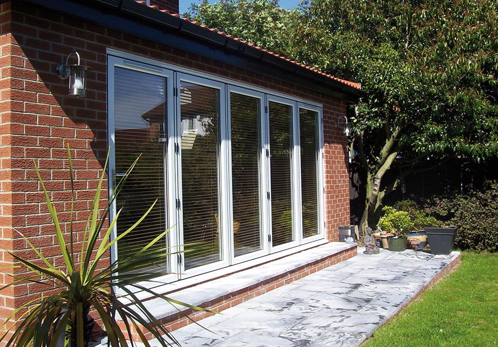 external picture of patio smart bi-fold doors in white