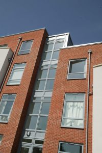 Tilt and turn windows shown on a multi-storey building